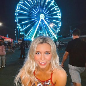 Girl in front of ferris wheell
